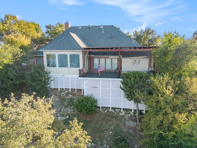 rear view of property featuring a balcony