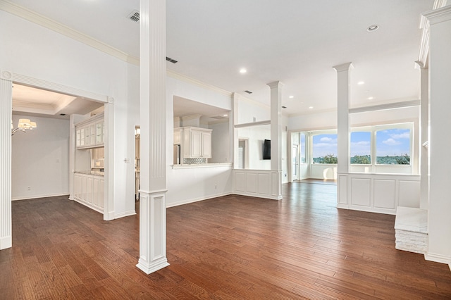 unfurnished living room featuring decorative columns, dark hardwood / wood-style flooring, and crown molding