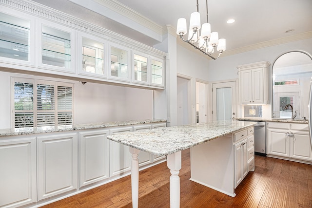 kitchen with pendant lighting, white cabinets, a chandelier, and dishwasher