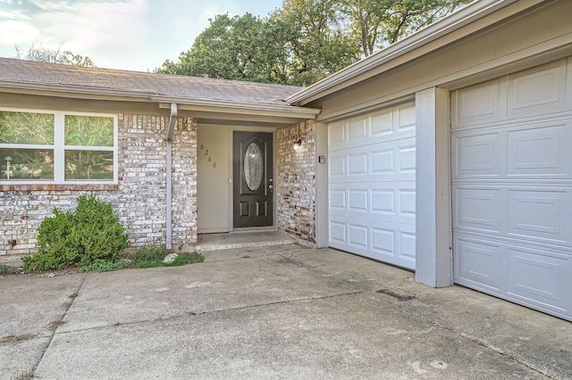 doorway to property with a garage