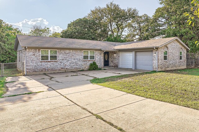 single story home featuring a garage and a front yard