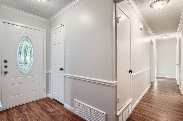 foyer featuring dark wood-type flooring, crown molding, and a textured ceiling