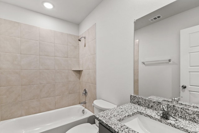 full bathroom featuring vanity, toilet, and tiled shower / bath combo