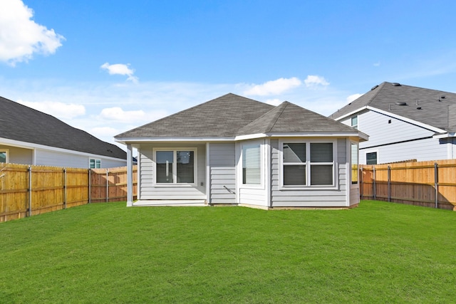 rear view of house featuring a lawn