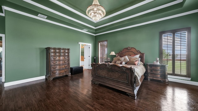 bedroom featuring a raised ceiling, ornamental molding, a chandelier, and dark wood-type flooring