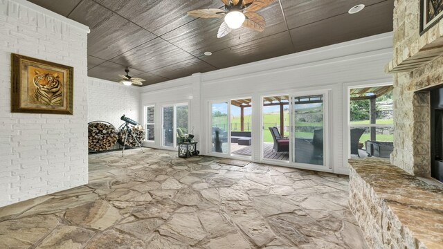 unfurnished sunroom with wooden ceiling and ceiling fan