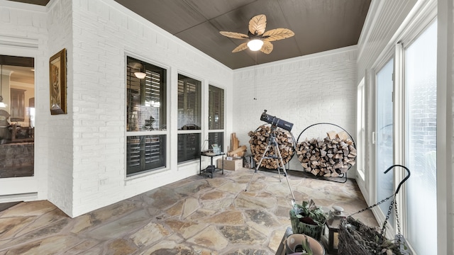 sunroom / solarium featuring ceiling fan