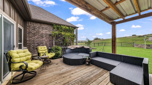 wooden terrace with a lawn and outdoor lounge area