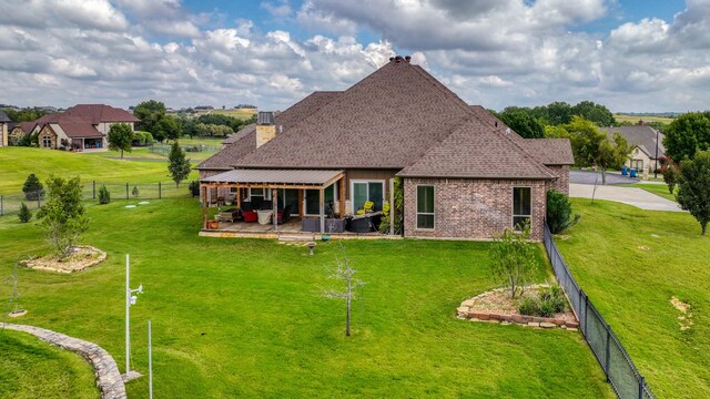 back of house with a yard and a patio area