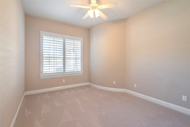 carpeted empty room featuring ceiling fan