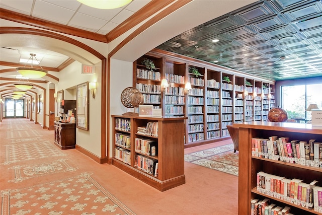 hallway with carpet floors and crown molding