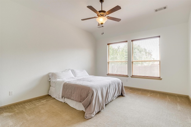 bedroom with light carpet, lofted ceiling, and ceiling fan