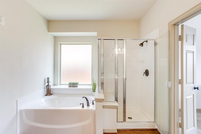 bathroom with shower with separate bathtub