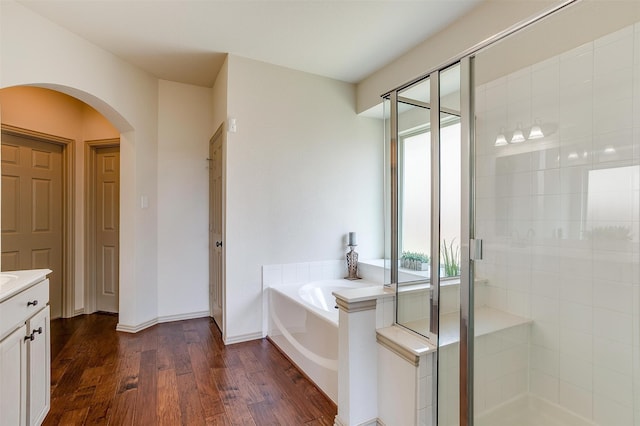 bathroom featuring hardwood / wood-style floors, vanity, and separate shower and tub