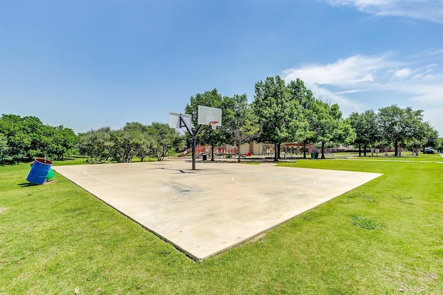 view of sport court with a lawn