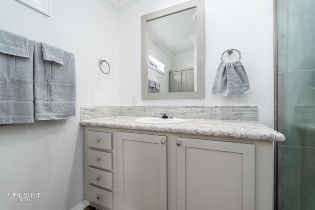 bathroom featuring tasteful backsplash, crown molding, and vanity