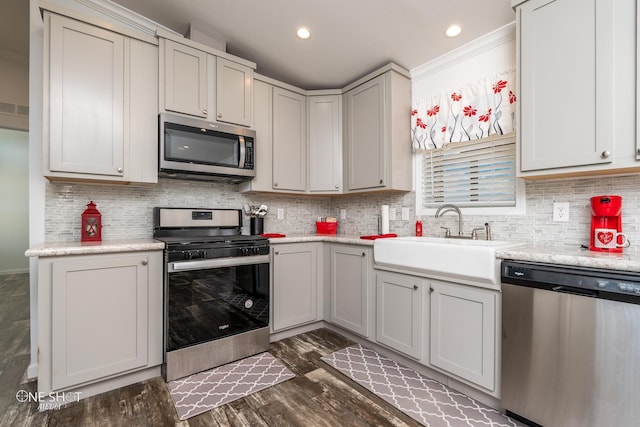 kitchen with crown molding, stainless steel appliances, sink, dark hardwood / wood-style floors, and tasteful backsplash