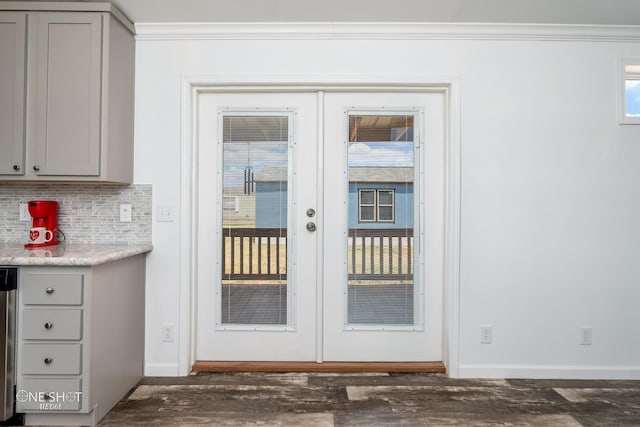 entryway featuring dark wood-type flooring, crown molding, and french doors