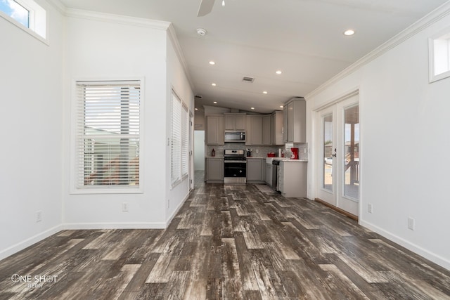 unfurnished living room featuring crown molding, ceiling fan, vaulted ceiling, and dark hardwood / wood-style flooring