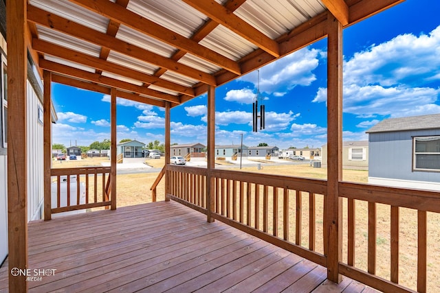 wooden terrace with a lawn