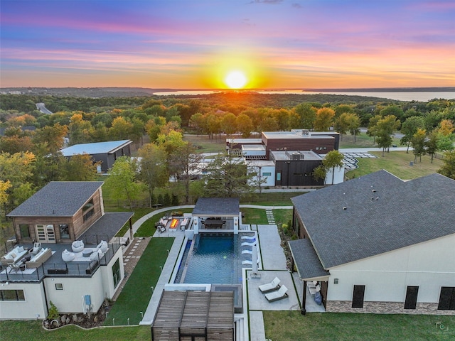 aerial view at dusk with a water view