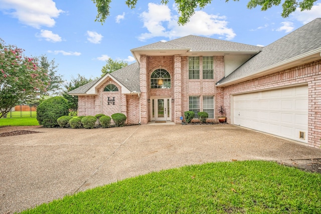 front of property featuring a garage and a front lawn