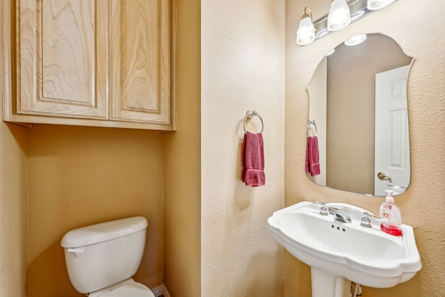 bathroom with toilet and sink