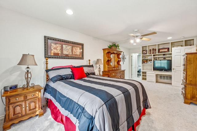 bedroom with ceiling fan and light carpet