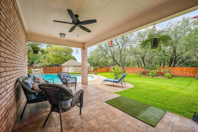 view of patio featuring ceiling fan and a fenced in pool