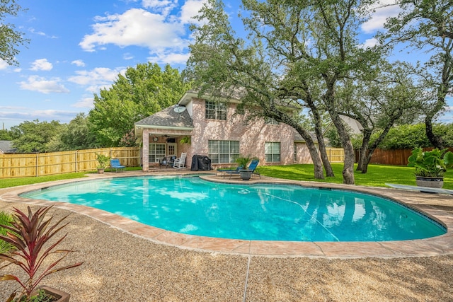 view of swimming pool with a lawn and a patio