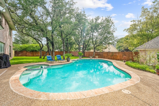 view of swimming pool featuring a patio area, a yard, and an in ground hot tub