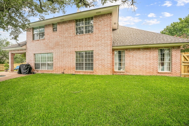 back of house with a yard