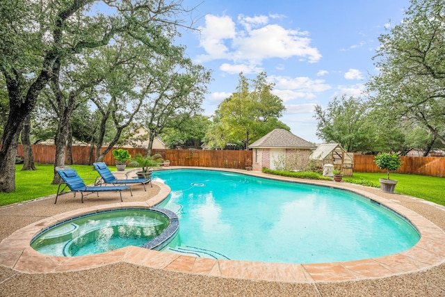 view of swimming pool with a lawn and an in ground hot tub