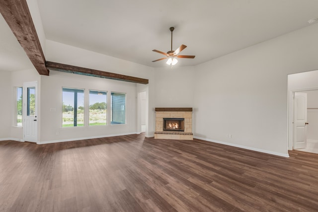 unfurnished living room with beamed ceiling, ceiling fan, and dark hardwood / wood-style floors