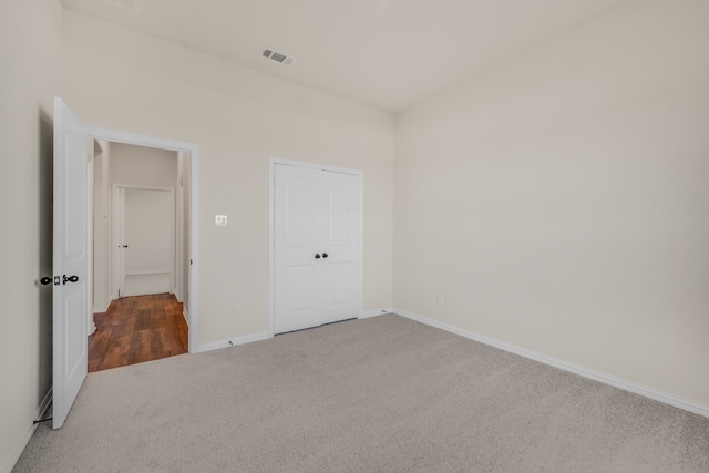 unfurnished bedroom with a closet and carpet floors