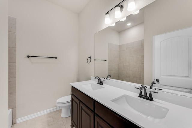 bathroom with a tub to relax in, vanity, toilet, and tile patterned flooring