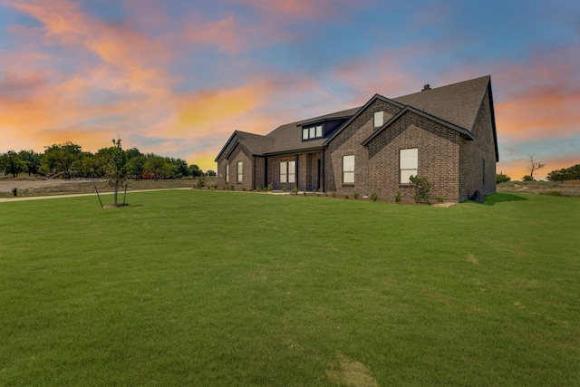 view of front of home with a lawn