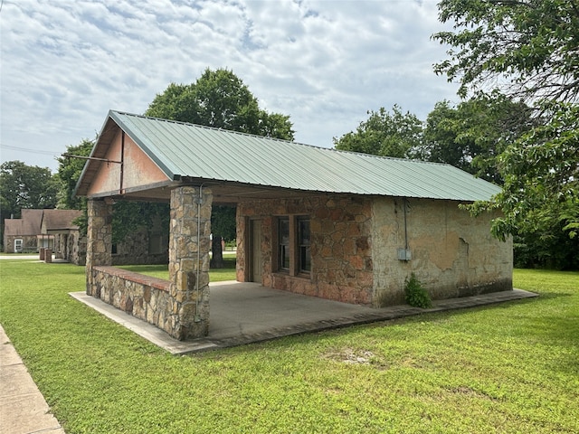 view of property's community with a patio area and a lawn