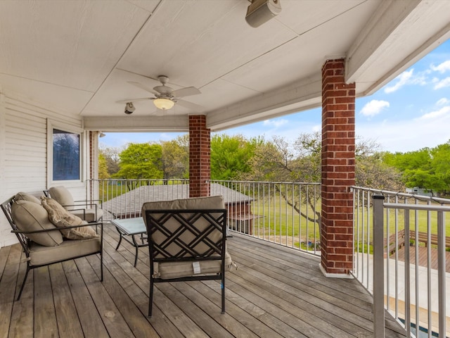 wooden terrace featuring ceiling fan and an outdoor hangout area