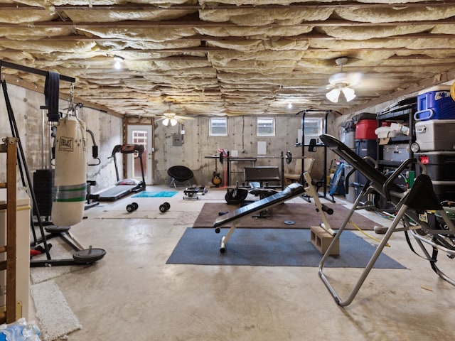 workout room with concrete floors and ceiling fan