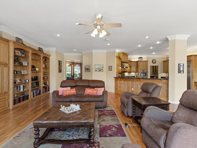 living room with ceiling fan, light hardwood / wood-style floors, and crown molding