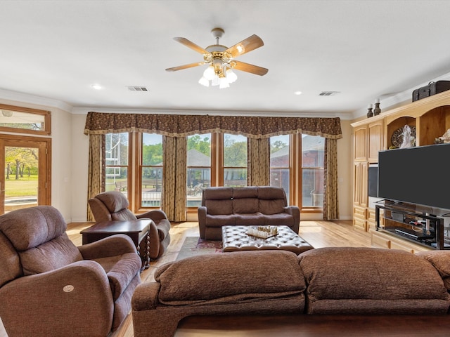 living room with ceiling fan, light hardwood / wood-style floors, and ornamental molding