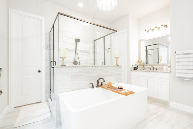 bathroom featuring vanity and shower with separate bathtub