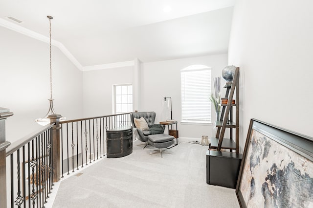 living area with lofted ceiling, crown molding, carpet floors, and a chandelier