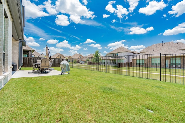view of yard with a residential view, a patio area, and fence