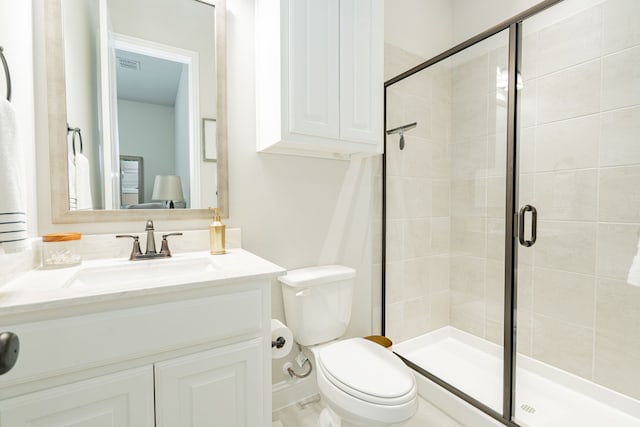 bathroom with toilet, a shower with door, and vanity