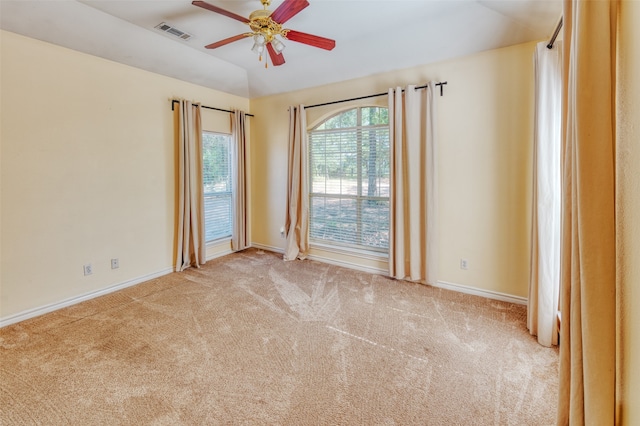 carpeted empty room featuring lofted ceiling and ceiling fan