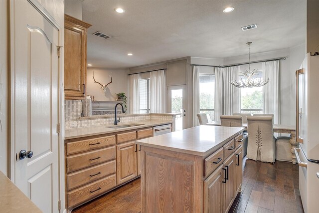 kitchen with plenty of natural light, sink, dark hardwood / wood-style floors, and a chandelier