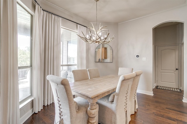 dining space featuring a healthy amount of sunlight, a chandelier, and dark hardwood / wood-style floors