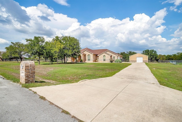 view of front facade with an outdoor structure, a garage, and a front lawn